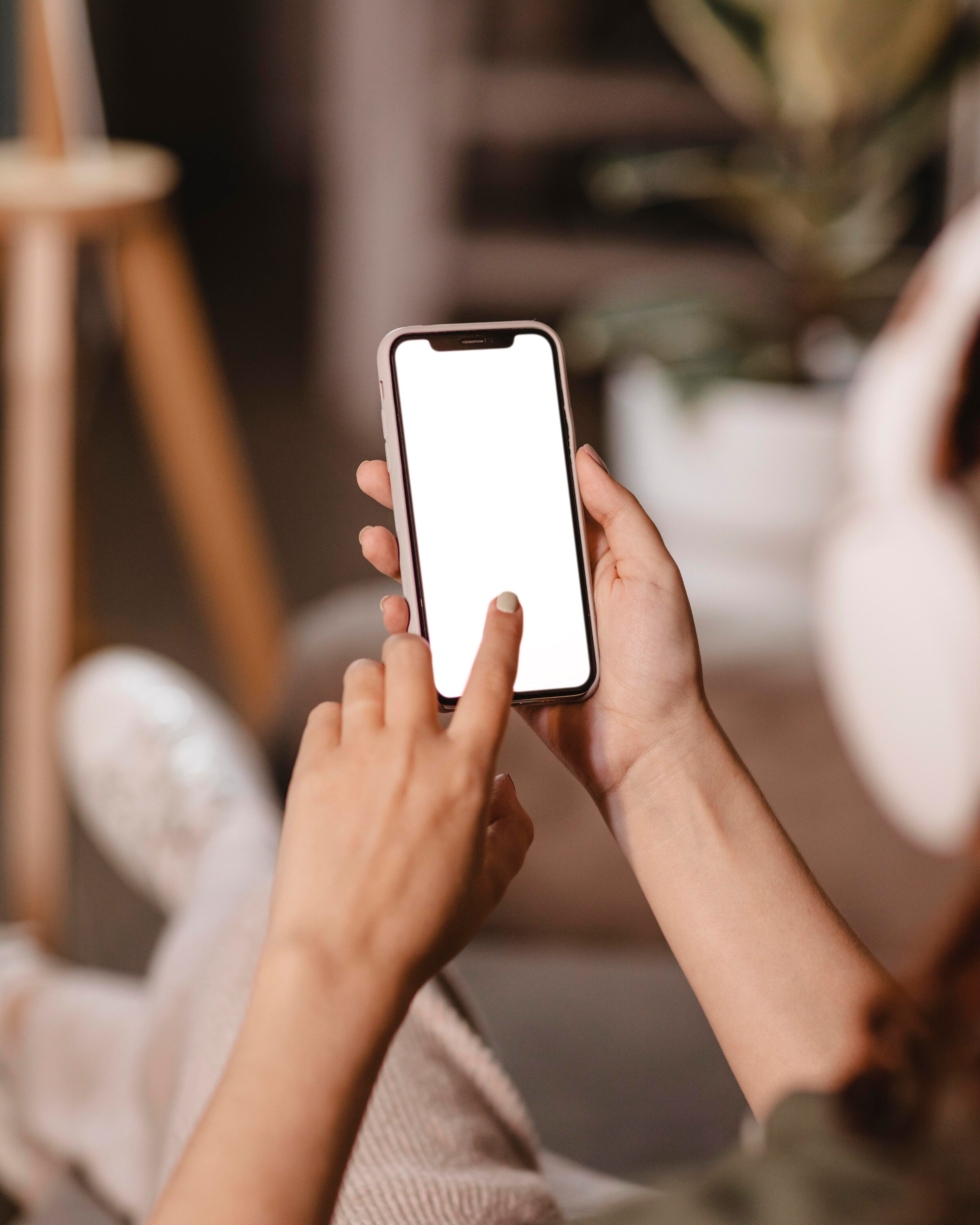 woman-using-modern-smartphone-headphones-home.jpg